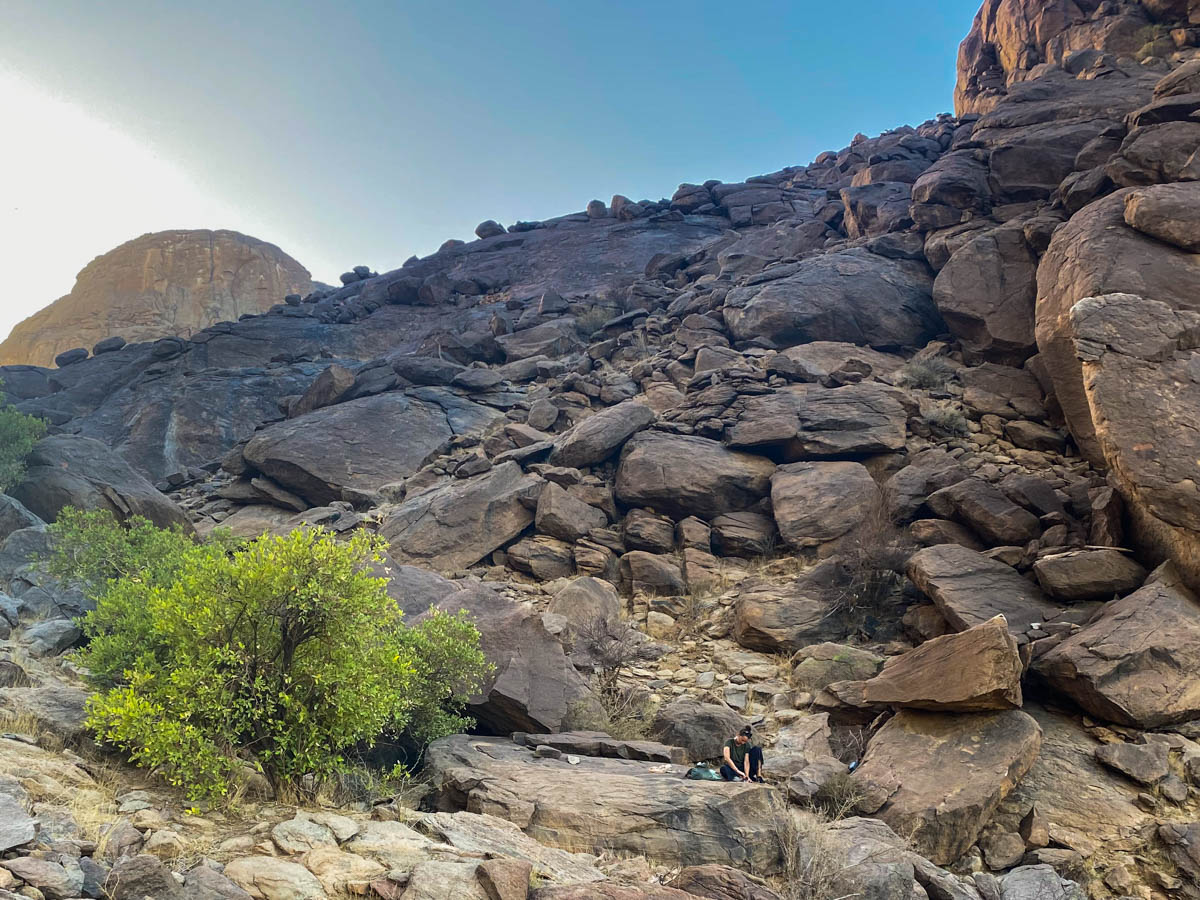 A slope littered with huge boulders and Anna looking tiny by comparison.