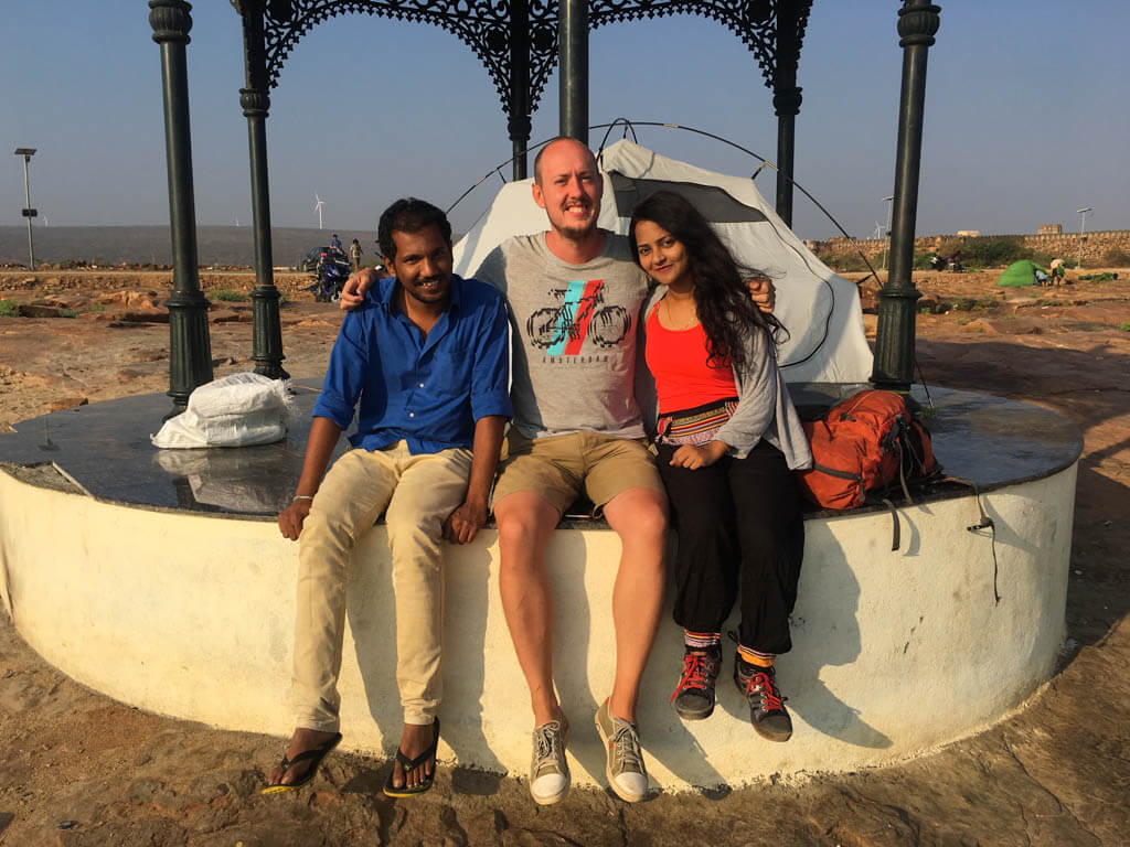 Rowan, Priya and Kesava sitting by our tent