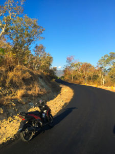 A road disappearing into the distance with my bike parked on one side.