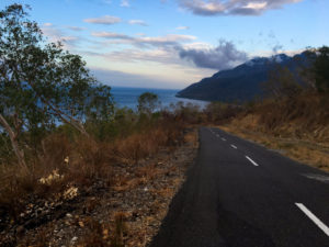 A road descending with the Banda sea in front.