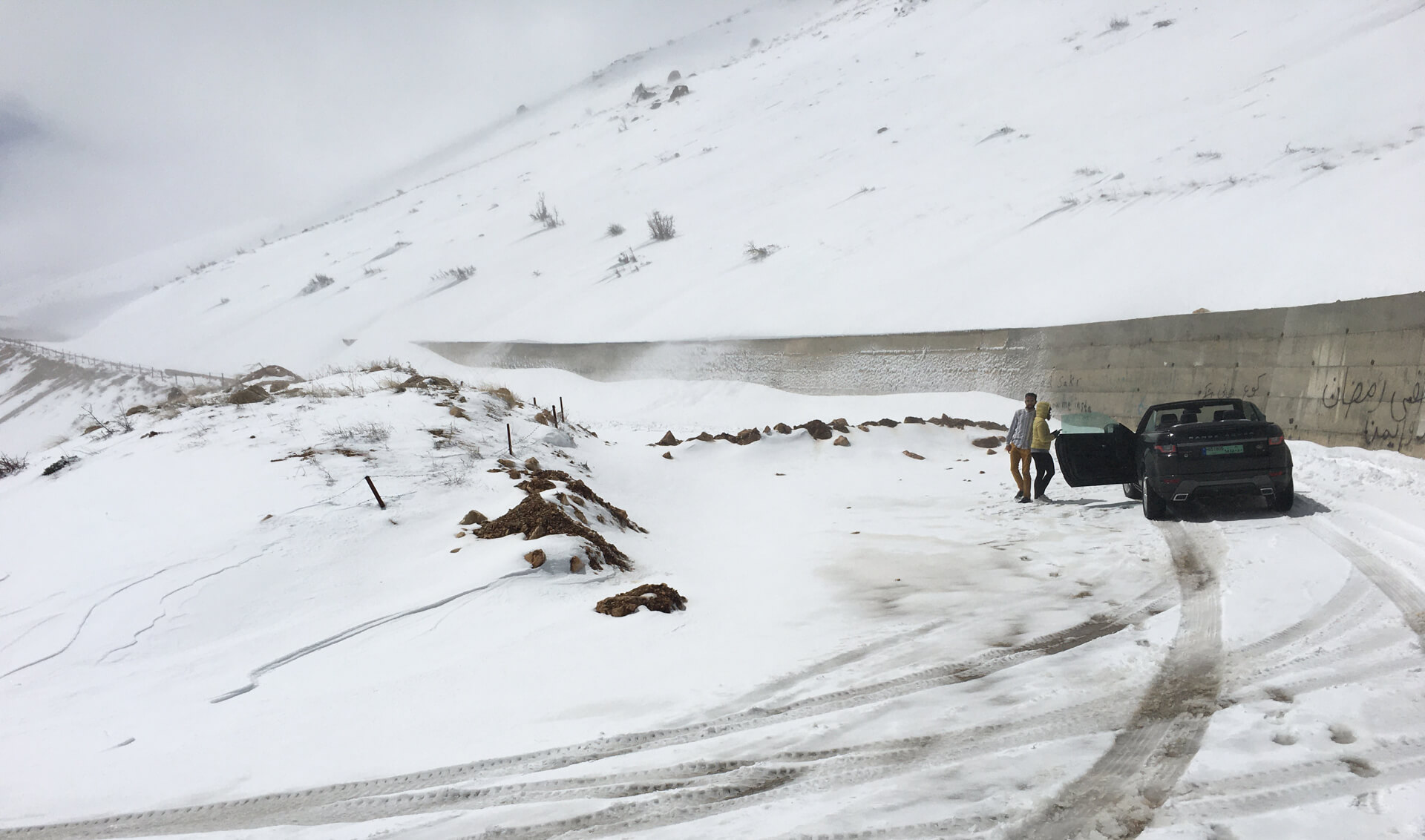 Our Range Rover convertible stopped in front of a row of stones with snow drifts on the other side