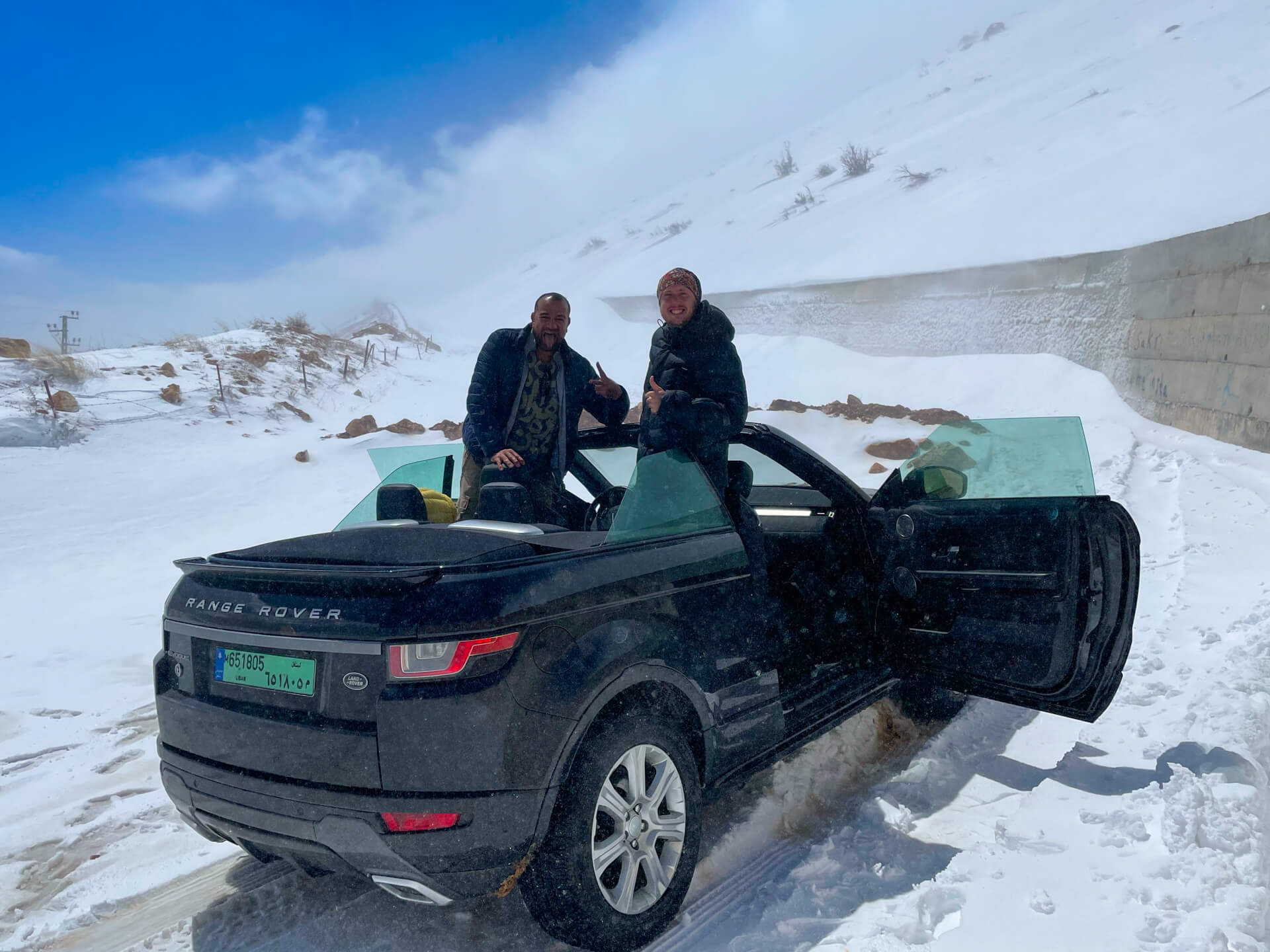 Reza and I posing on the convertible in the snow.