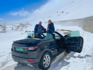 Reza and I posing on the convertible in the snow.