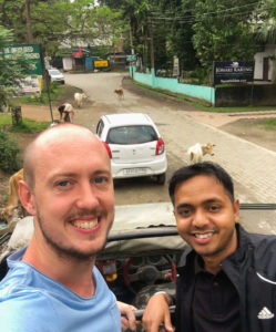 Rupam and I standing in the back of our safari vehicle on a street before entering the national park.
