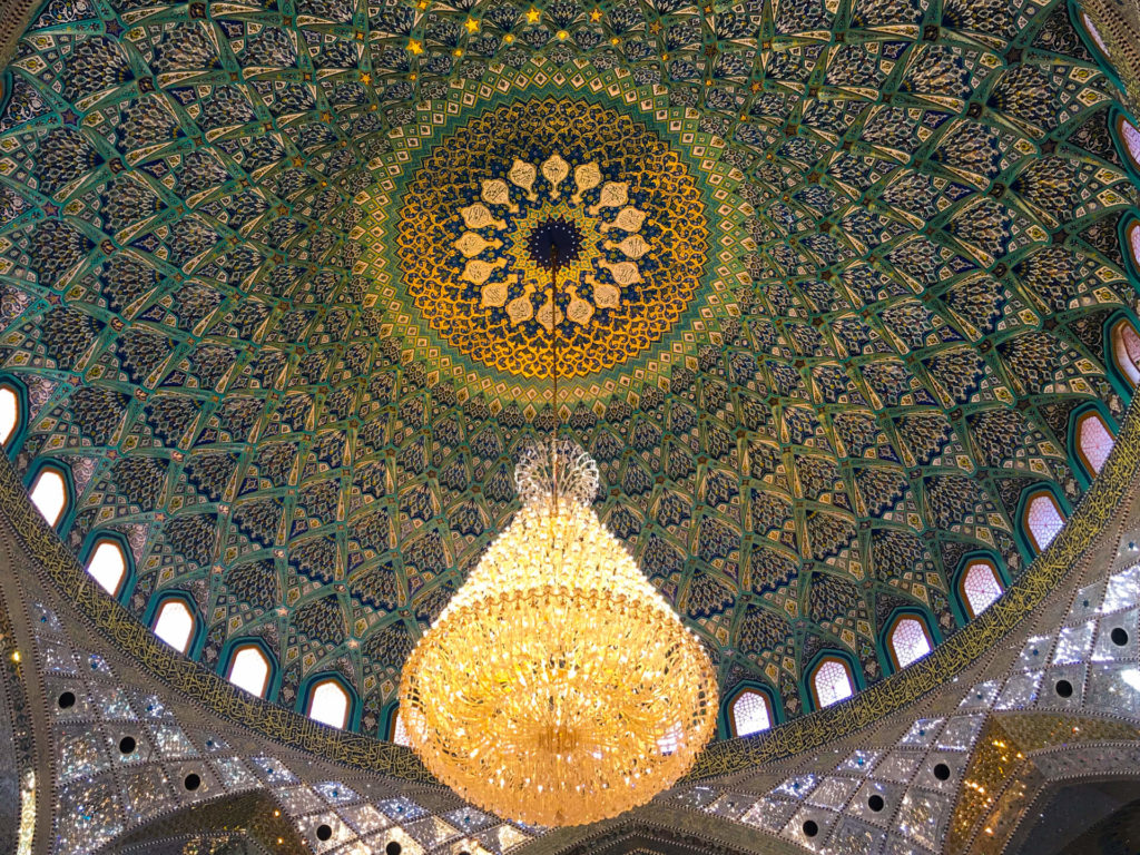 Brilliantly patterned inside of the dome with an ornate chandelier hanging below