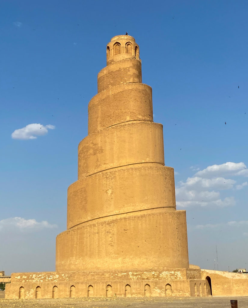 The Malwiya Minaret with a person standing on top.