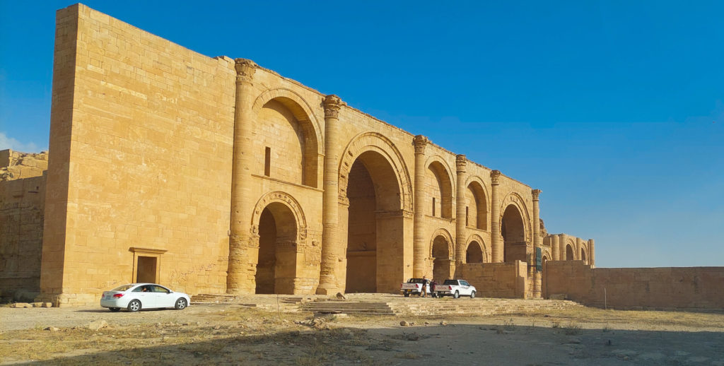 The main building of Hatra with our cars parked out front.