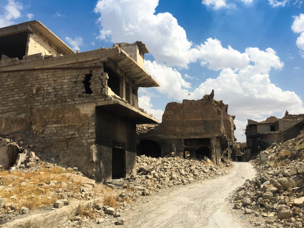 A narrow road winds between bombed-out buildings in Mosul's old town.