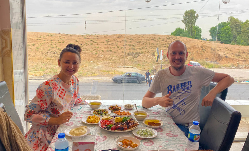 Anna and I sitting at a table spread with a delicious meal of skewers and side dishes.