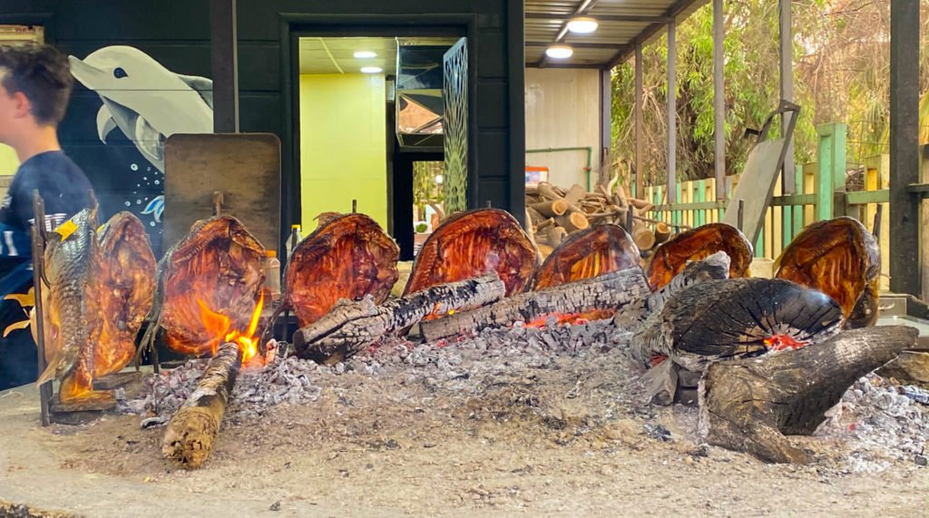 Fish being grilled on an open fire in Mosul.