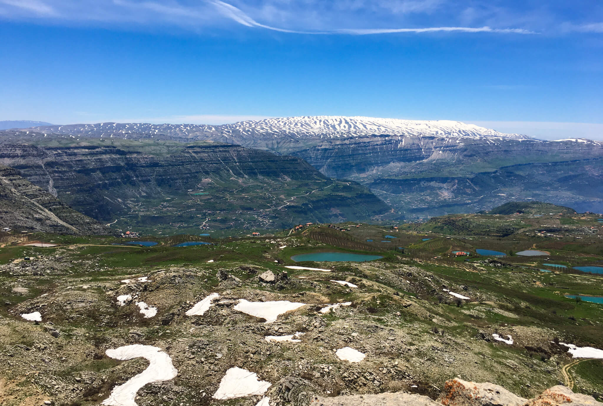 A view over the mountain landscape with snow on the distant mountains.