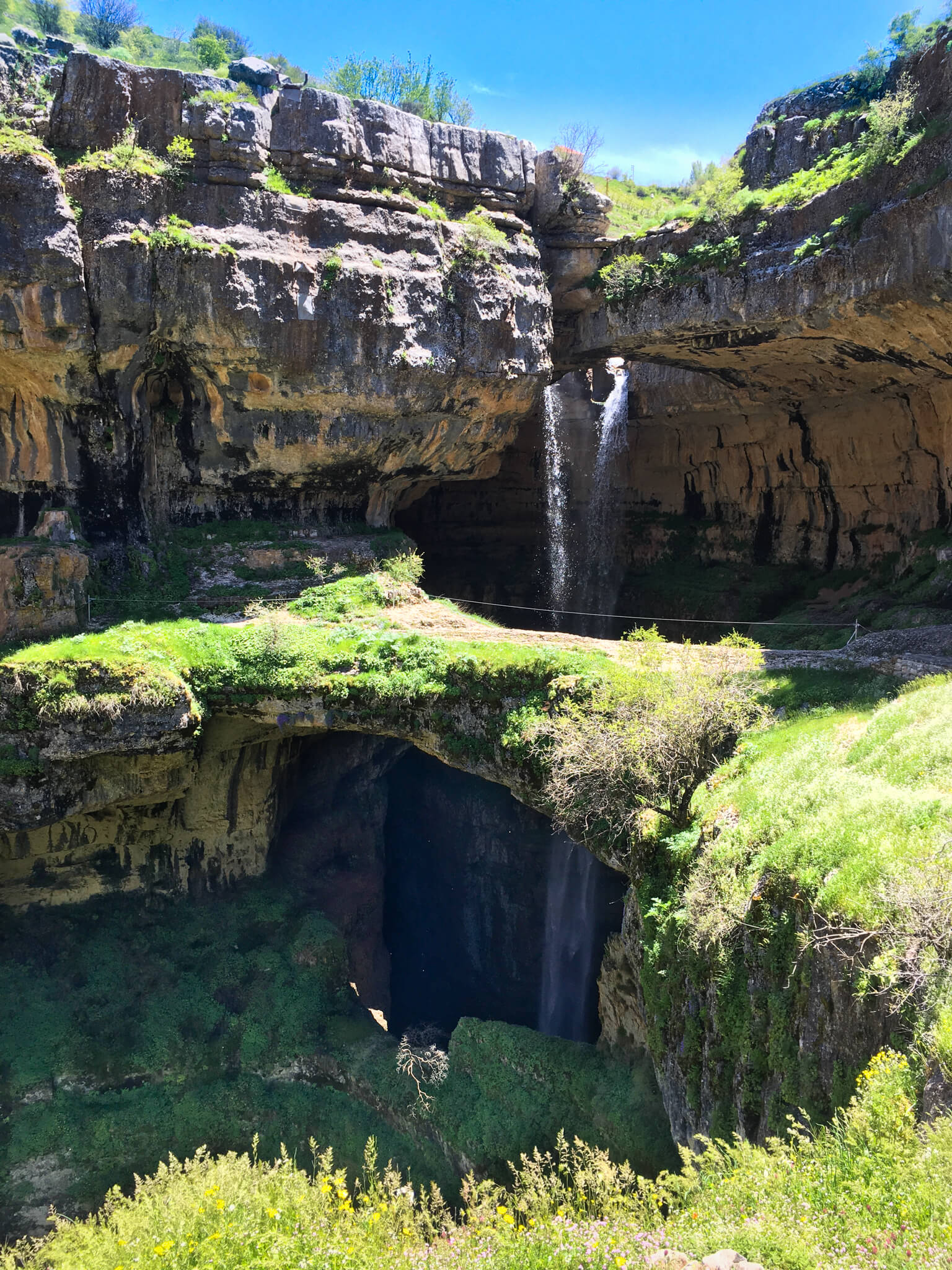 A waterfall disappearing through three tiers of limestone