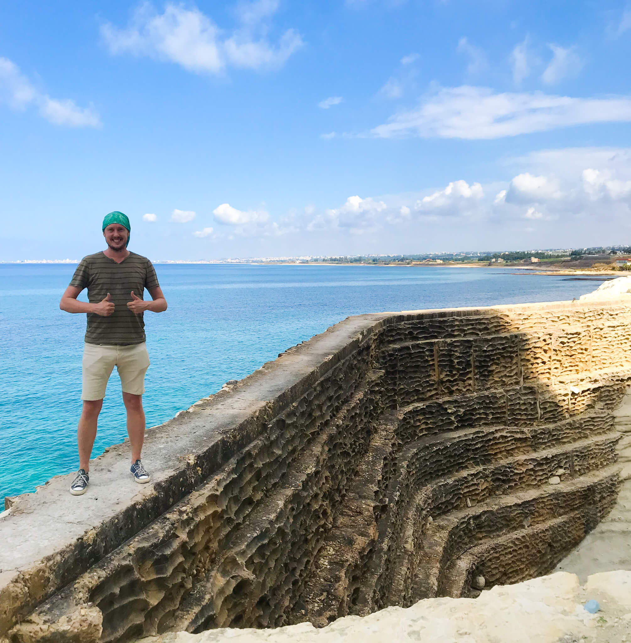 Me, standing on a sea wall with the blue Mediterranean in the background.
