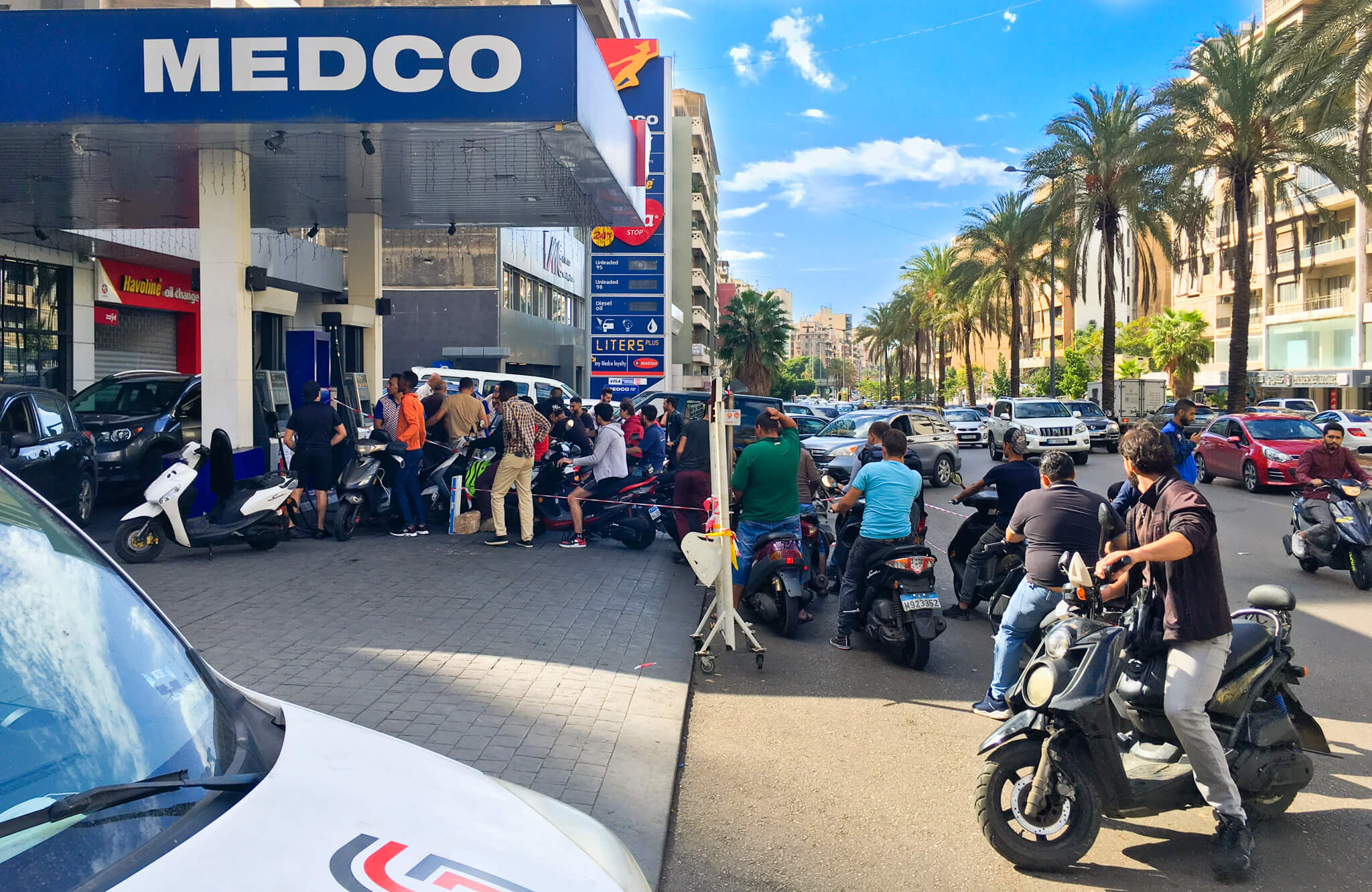 Queue of motorbikes at a MEDCO fuel station