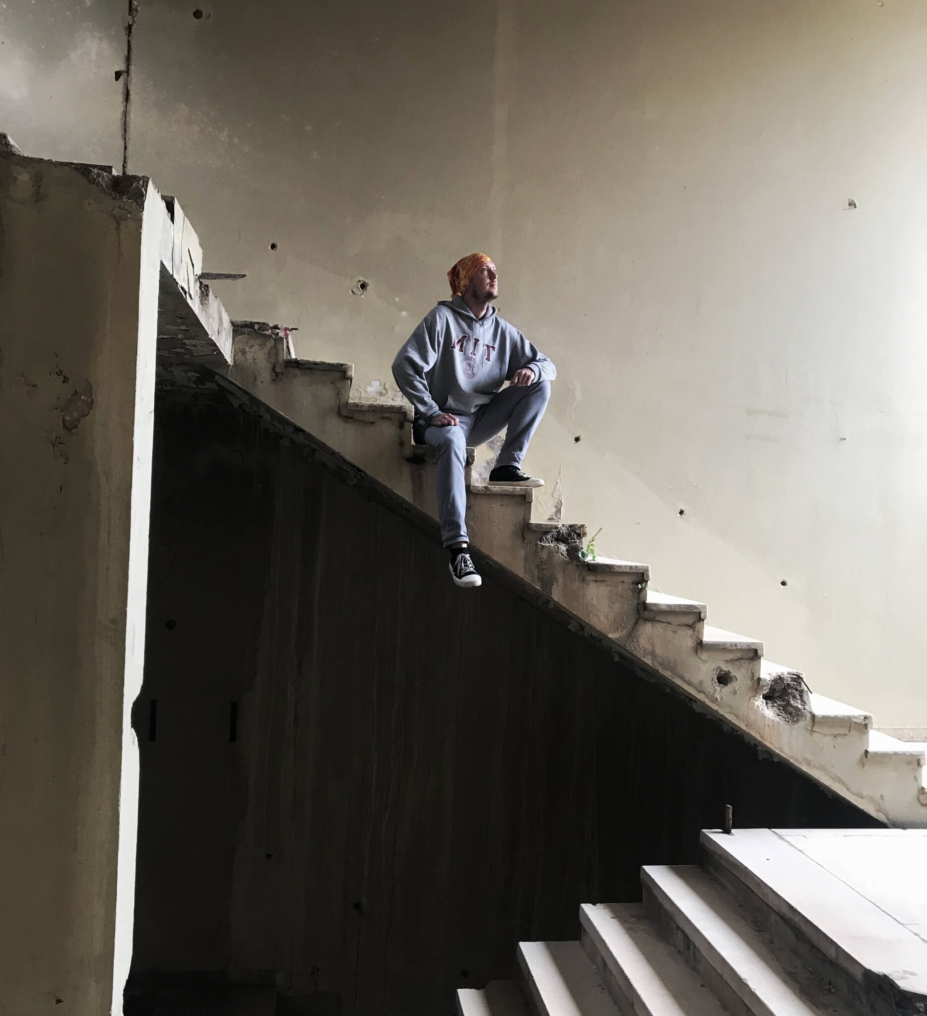 Me, sitting on the stairs in an abandoned building.