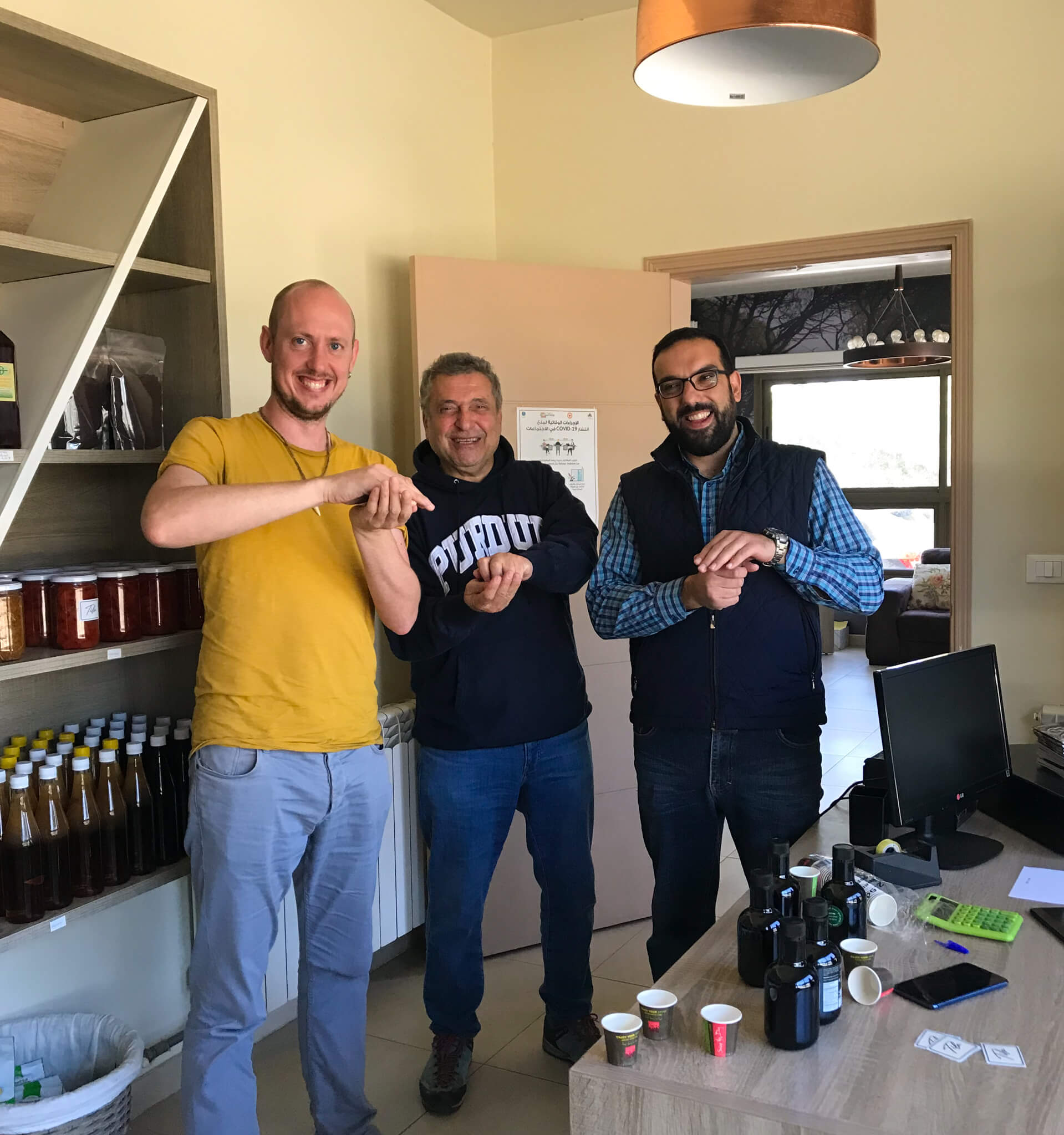 Me and the owner of the J.Grove olive oil shop holding cups of olive oil while doing a tasting. 