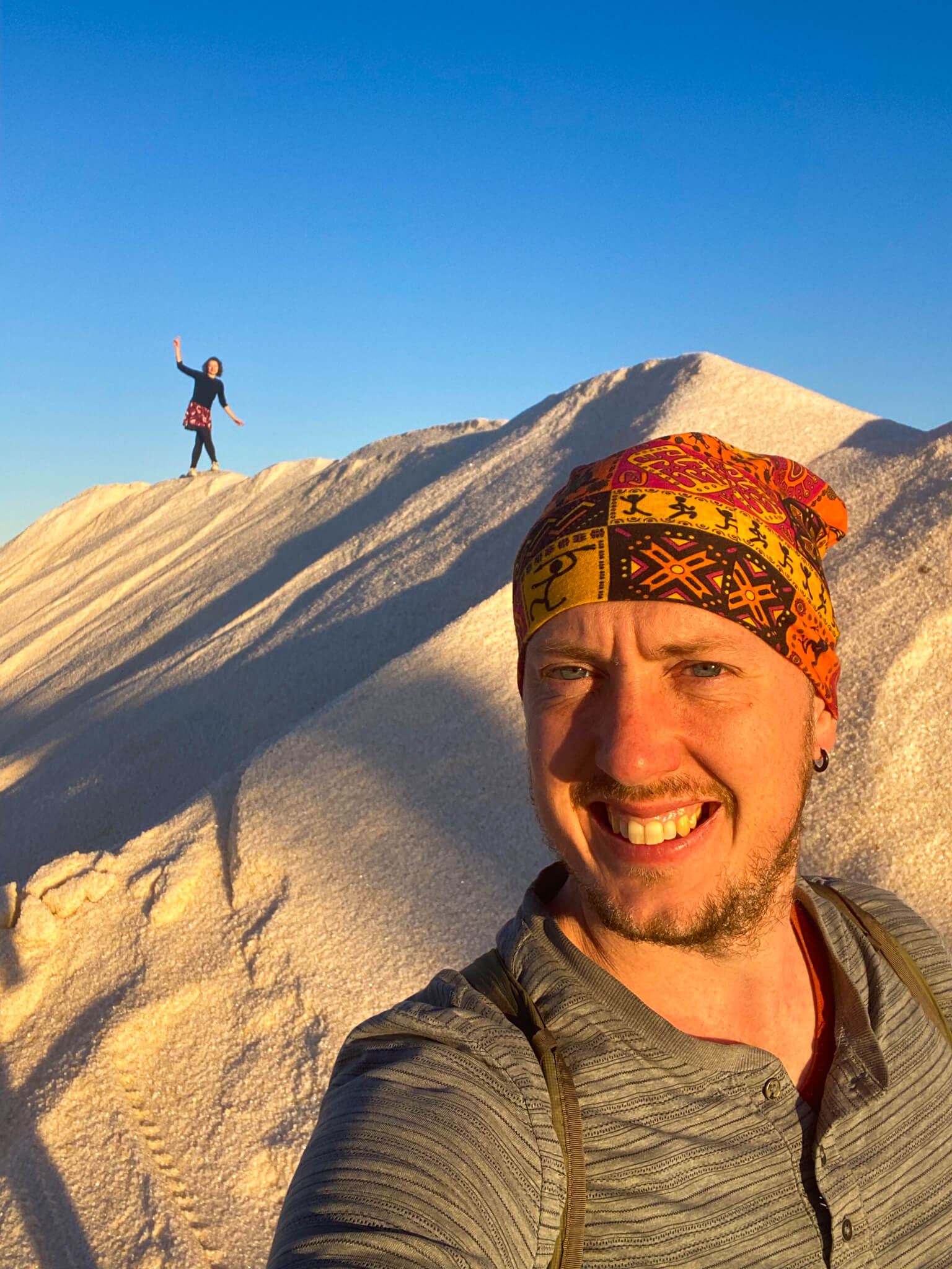 Me standing in front of a mountain of salt with Anna climbing it in the background.