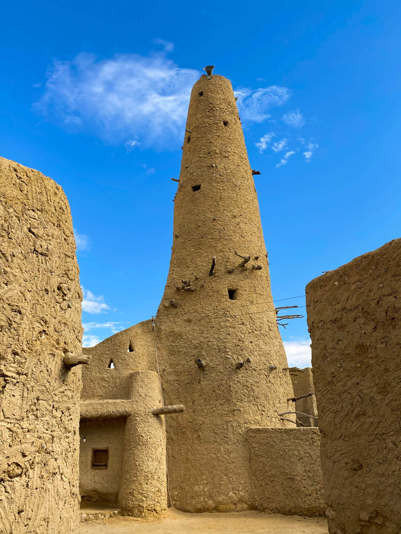 Mud minaret inside with wooden beams sticking out of it