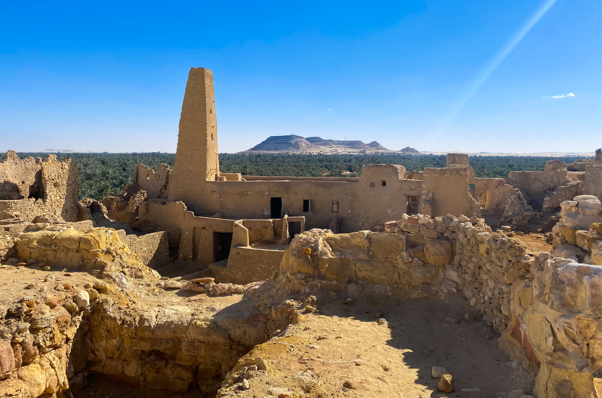 Mud buildings of the Temple of Amun with Dakrur Mountain in the background.