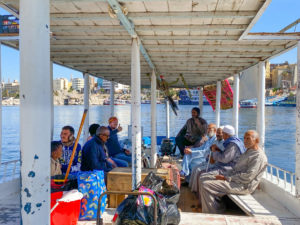 Me, sitting with a group of local people on a wooden ferry.