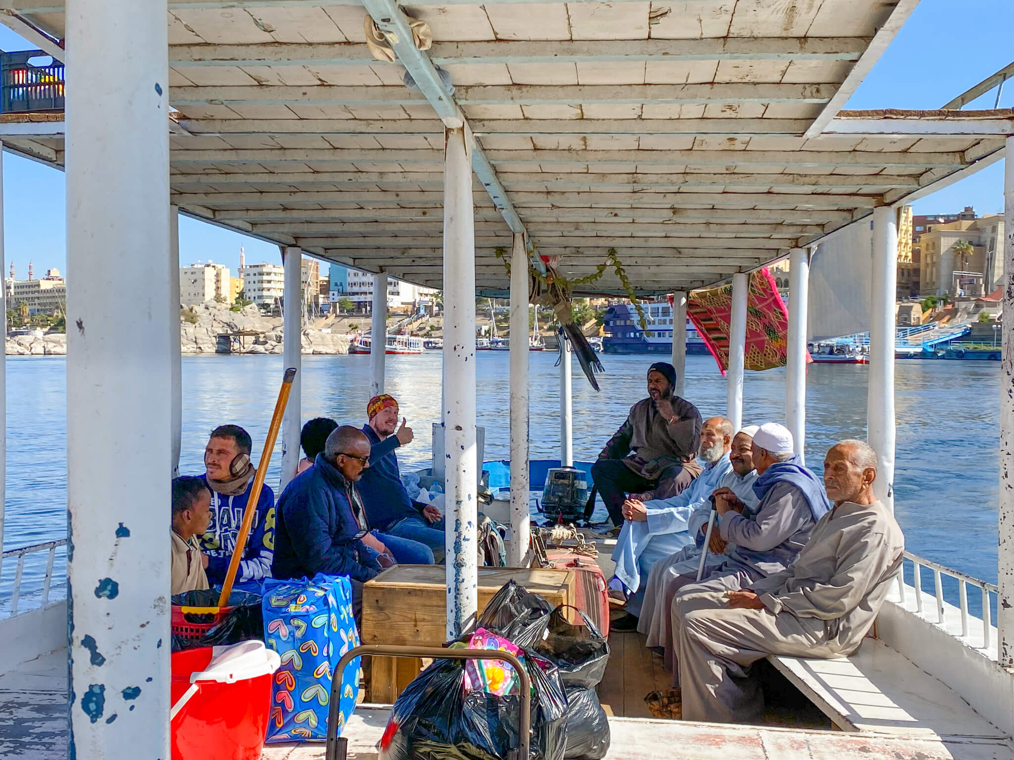 Me, sitting with a group of local people on a wooden ferry.