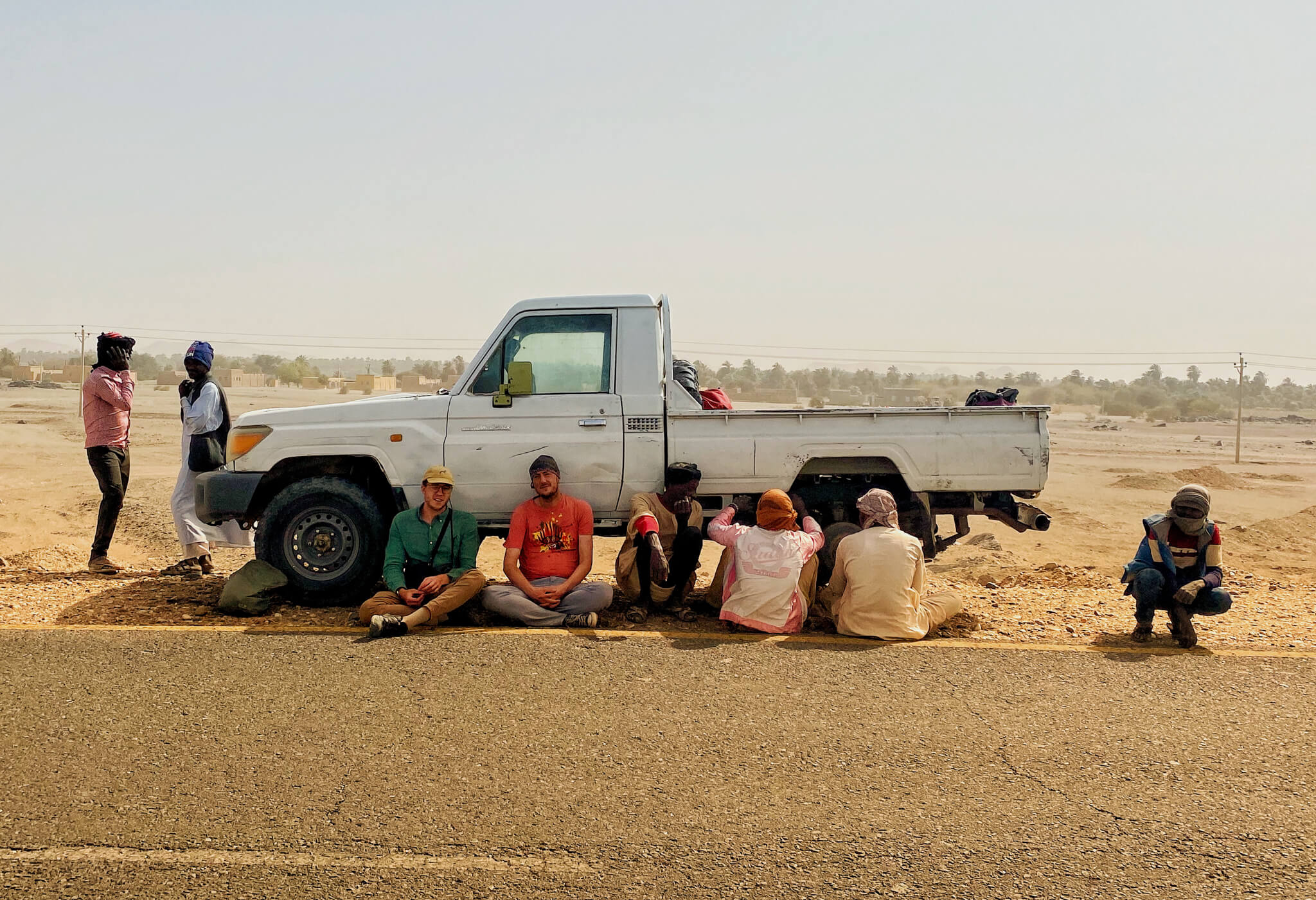Me, Daniel from South Africa and a group of Nubian guys sitting around a broken down pickup in the Sudanese desert.