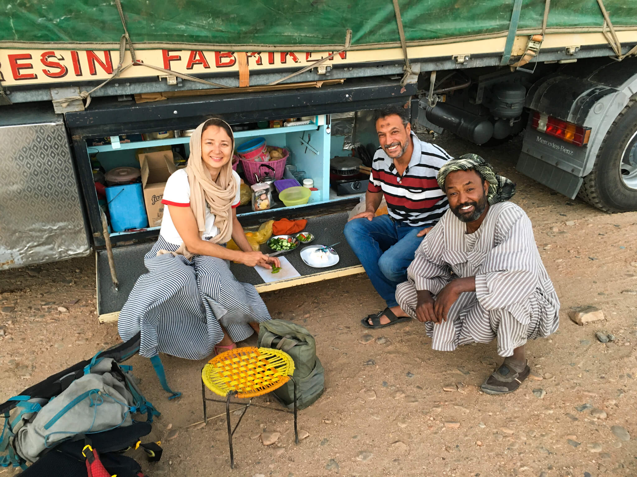 Anna, our truck driver and a Nubian guy who hitchhiked with us eating iftar by the truck.