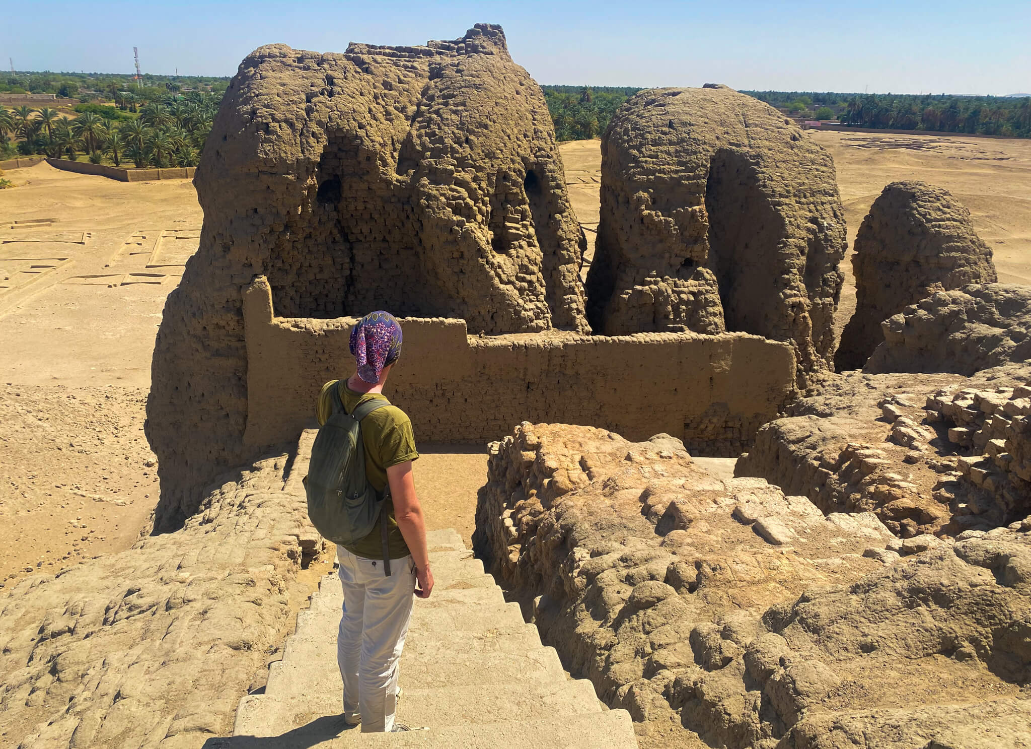 Me, standing on the steps near the top of the Western Deffufa looking out over its 3 ancient towers.