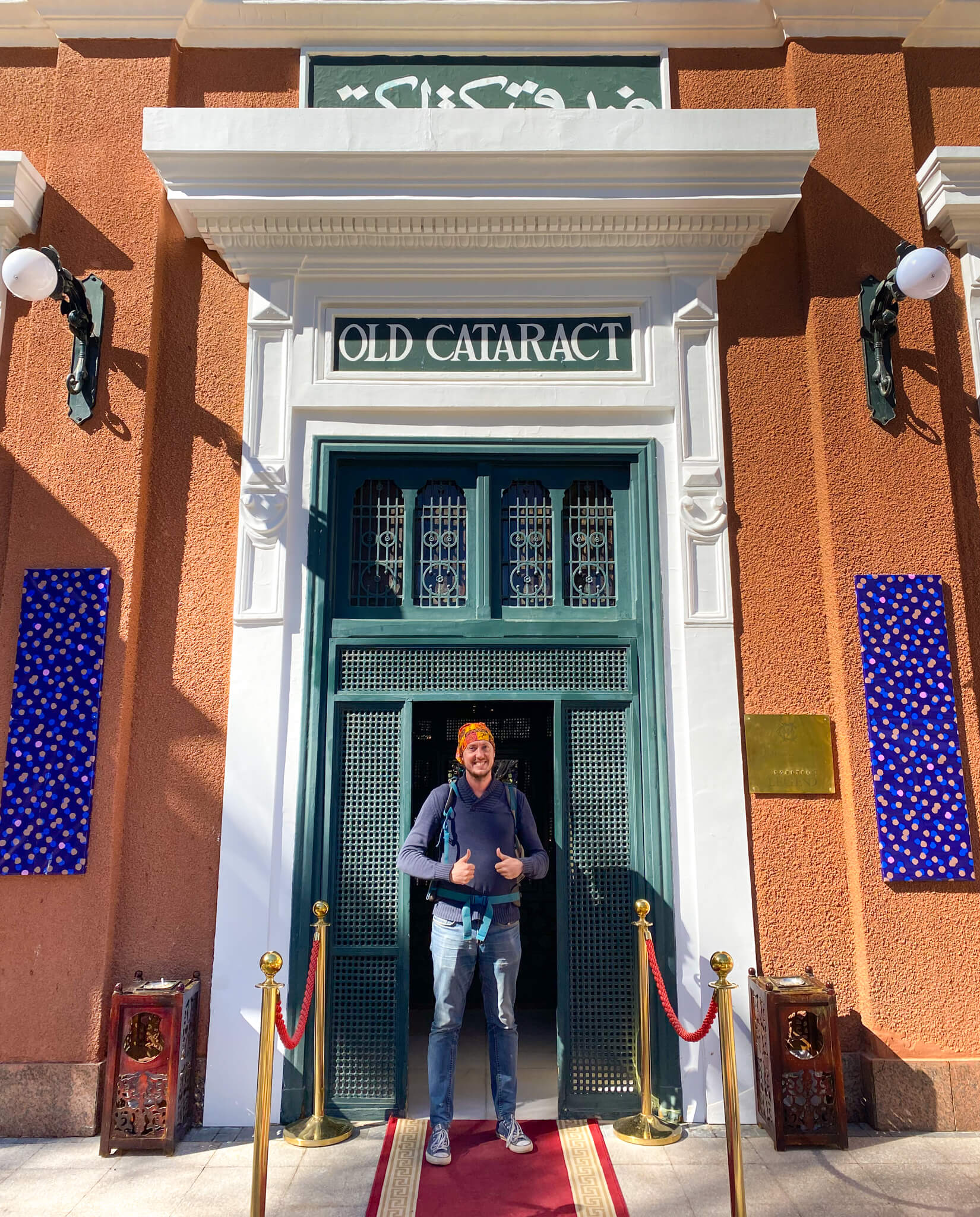 Me, standing at the door to the Old Cataract Hotel.  A sign above my head displays the hotel's original name.