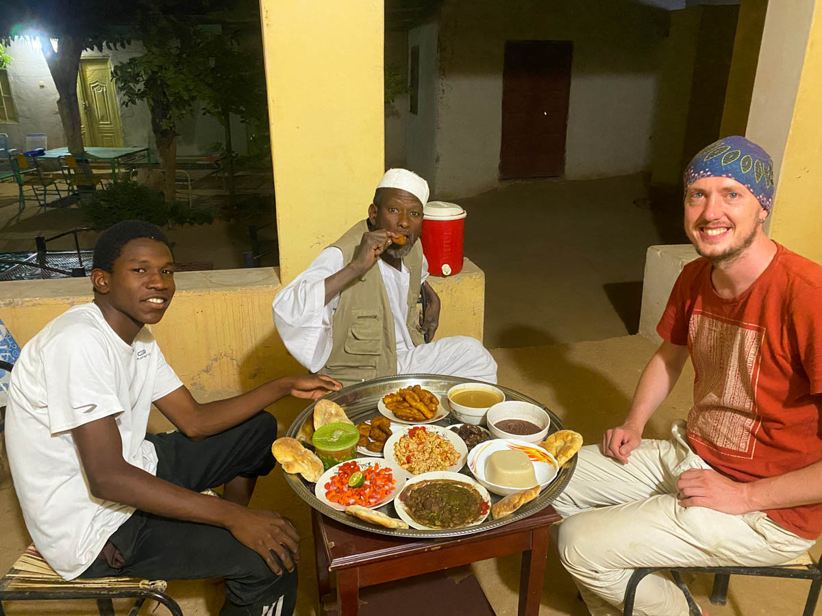 A huge meal spread out on a table with me Ahmed Mousa and his son.