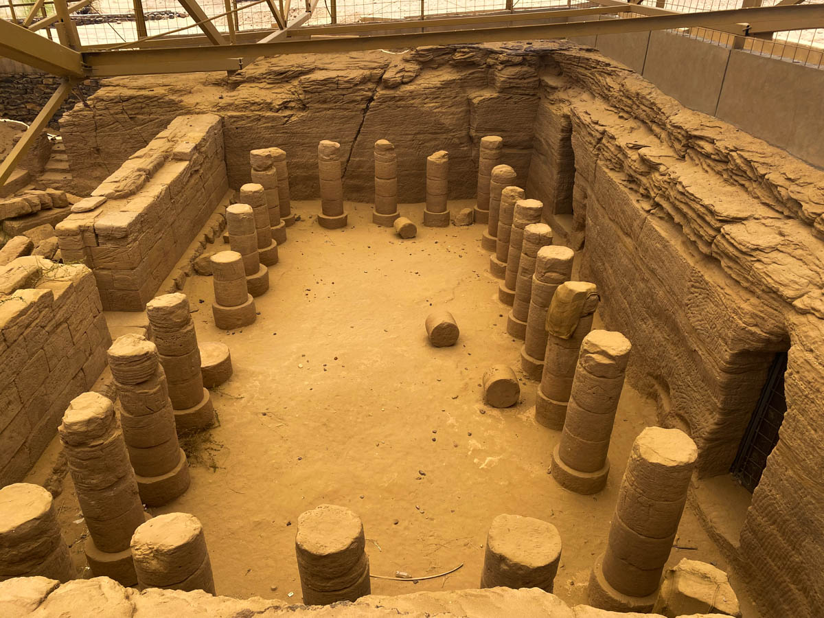 A large rectangular room dug into the ground and lined with pillars on all sides.