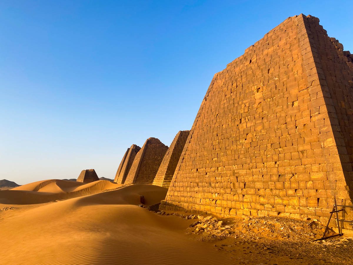 The pyramids of Meroe standing in the copper-coloured sand