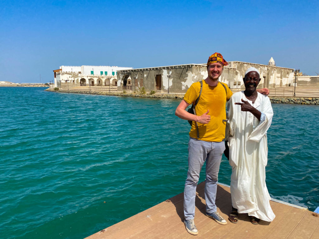Me and the local Sudanese man who showed me around Suakin Island standing in front of the Red Sea.