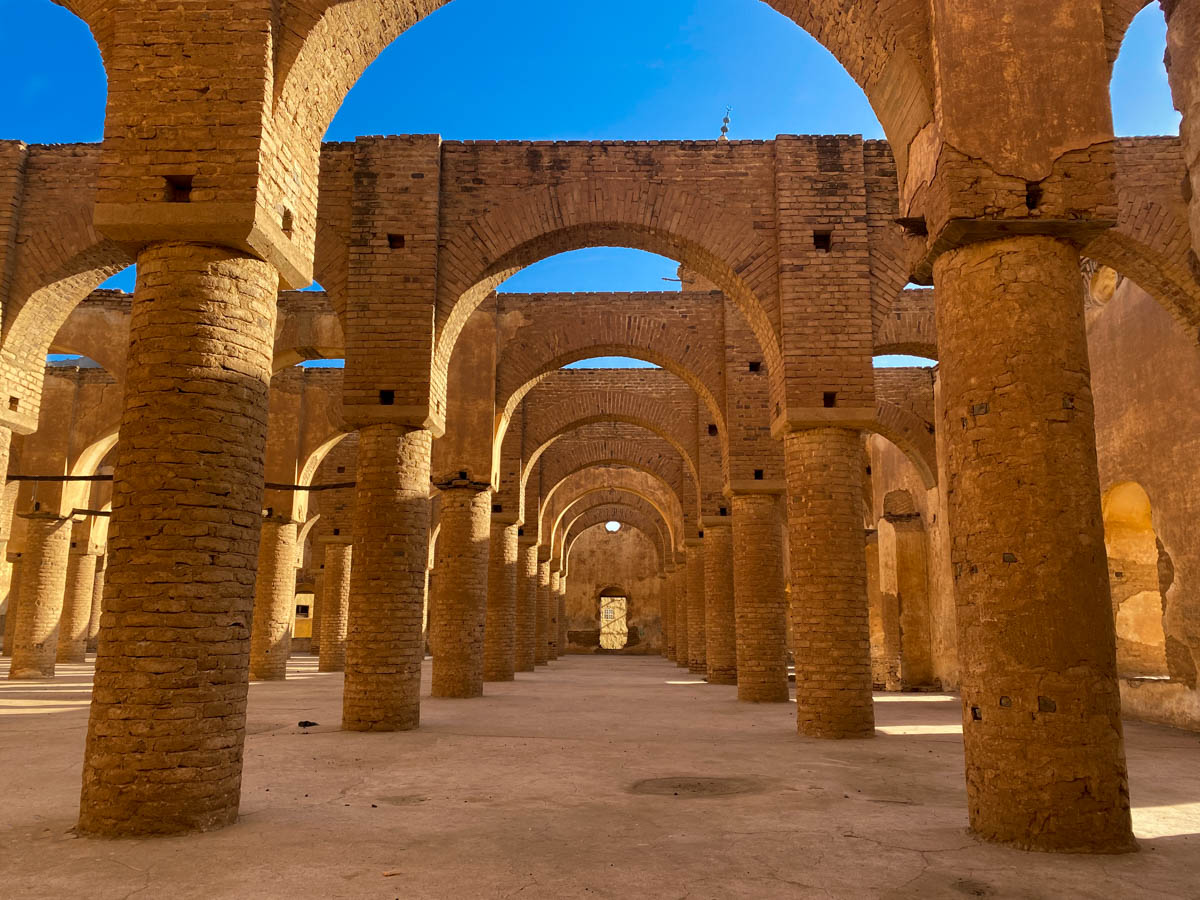 A series of brick archways in a large courtyard.